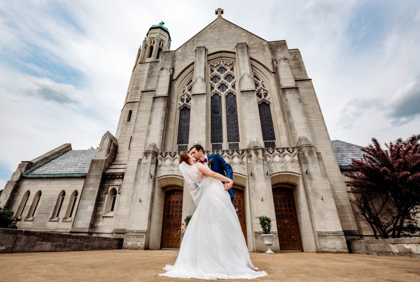 Couple kiss on their wedding day in front of church