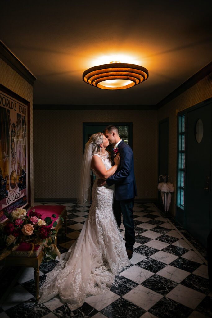 bride and groom kissing under retro light at Chatol House and Gardens Centralia, MO