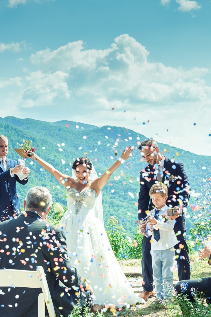 bride celebrating with confetti mountain top wedding