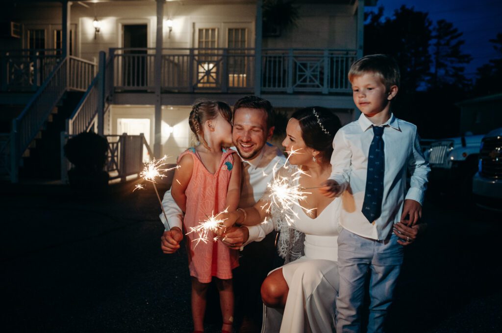 bride and groom with kids and sparklers