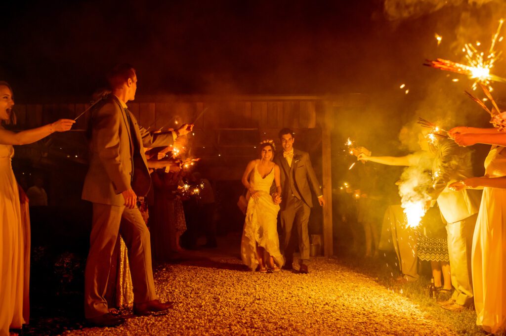 Married couple exits through sparkler tunnel Coopers Ridge