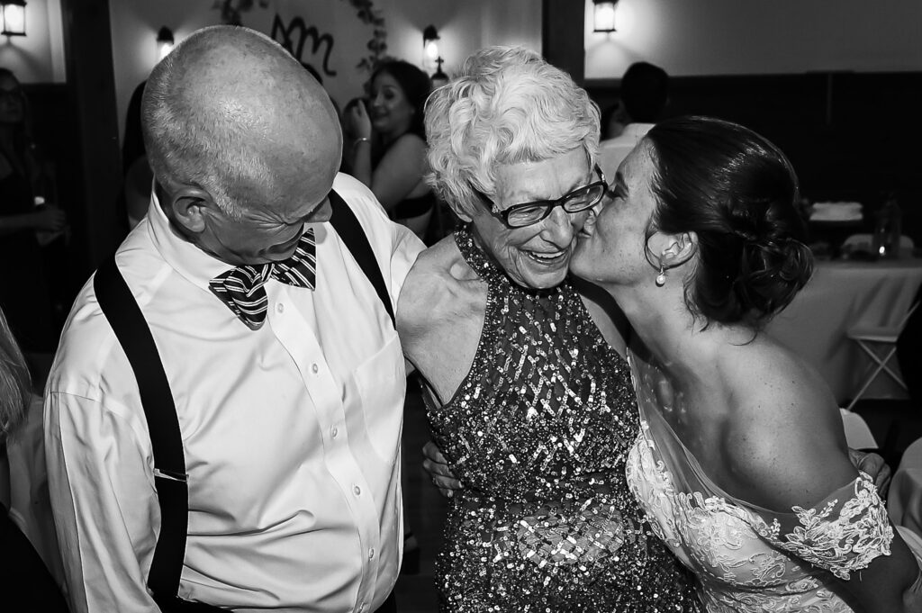 bride kissing grandma in fancy sequin dress