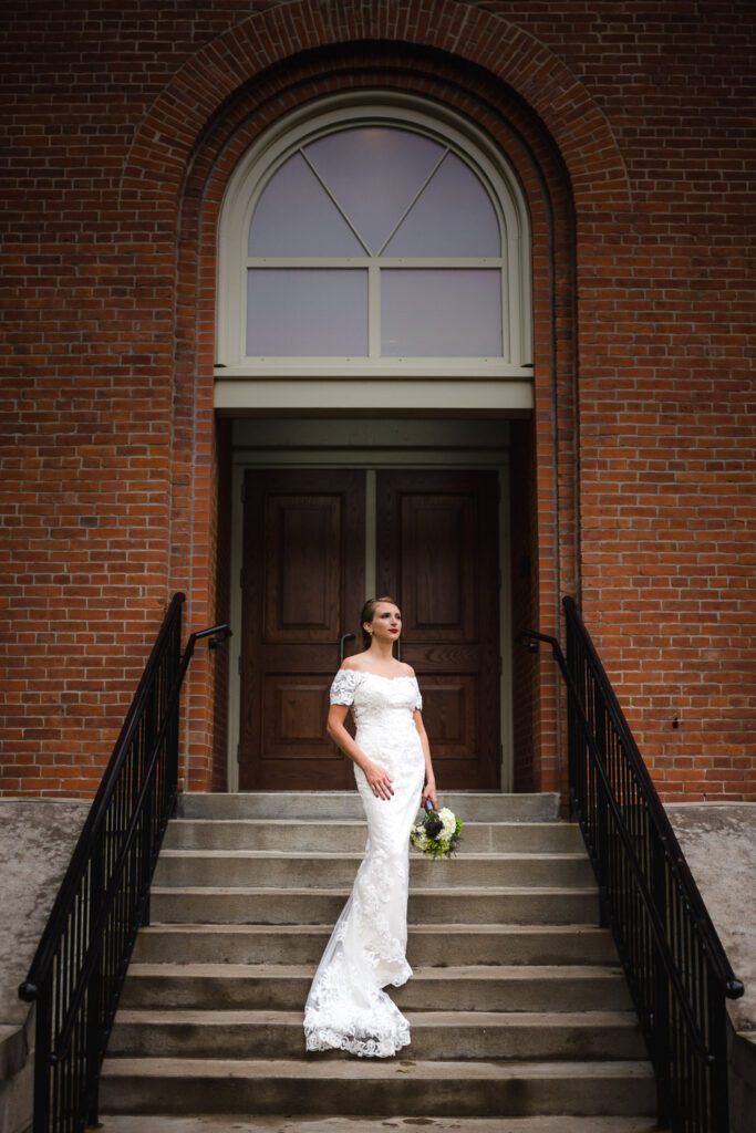 bride posing on stairs with Engineering archway Mizzou