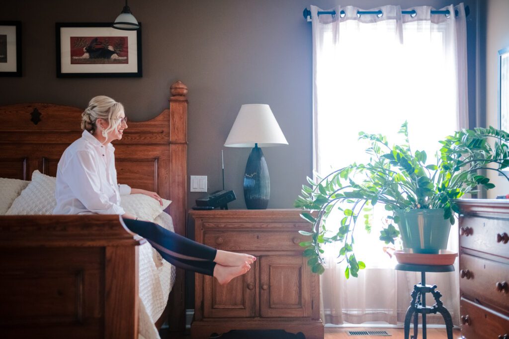 bride relaxing on bed before wedding Columbia, MO