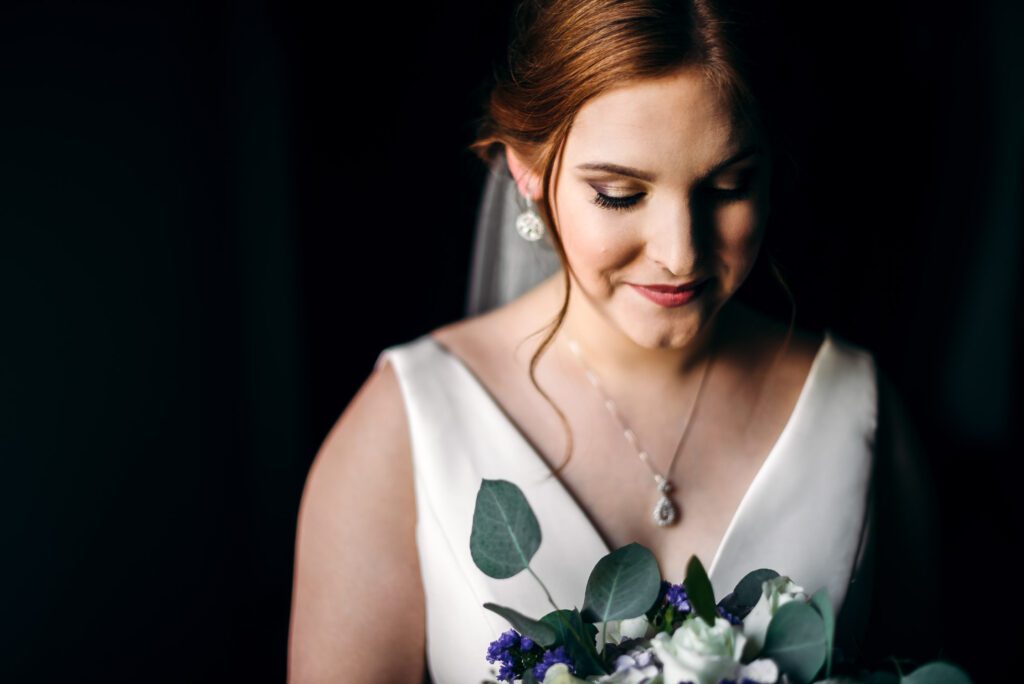 bride smiling holding flowers