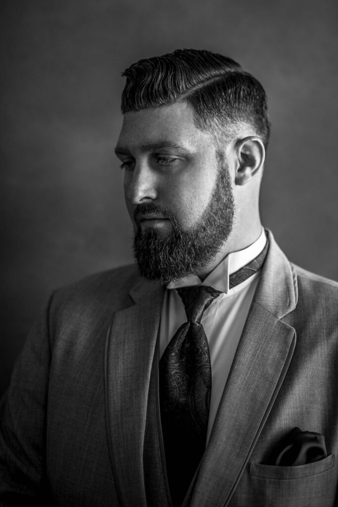 fancy groom portrait with hard part in hair