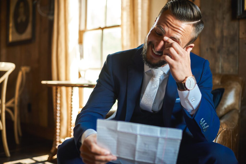 Groom reading bride's letter Blue Bell Farm Fayette, MO