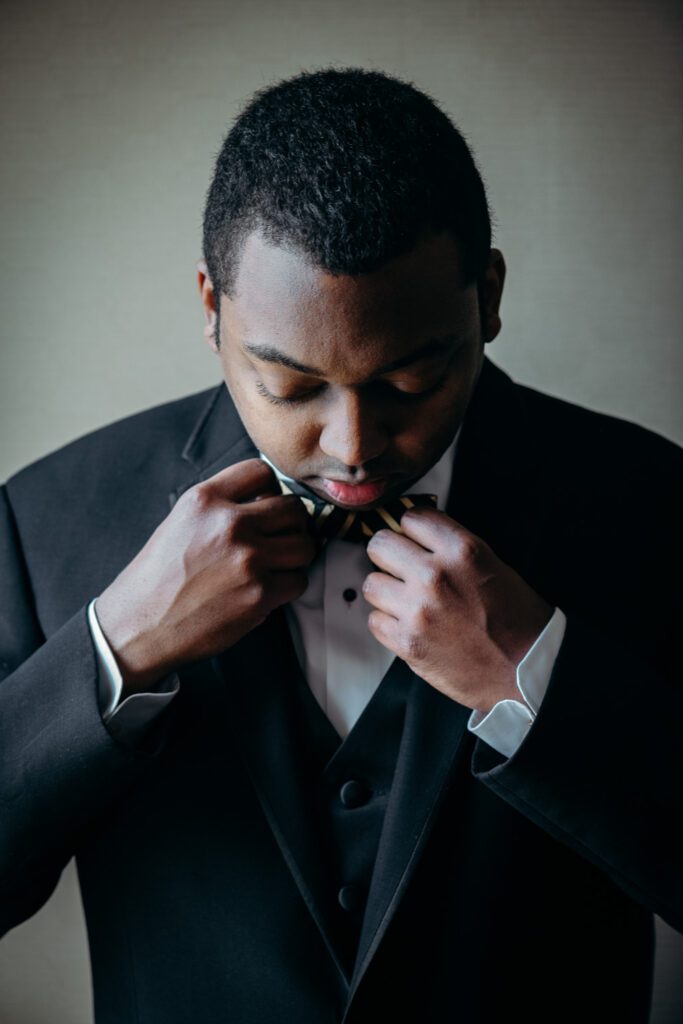 groom portrait adjust mizzou tie