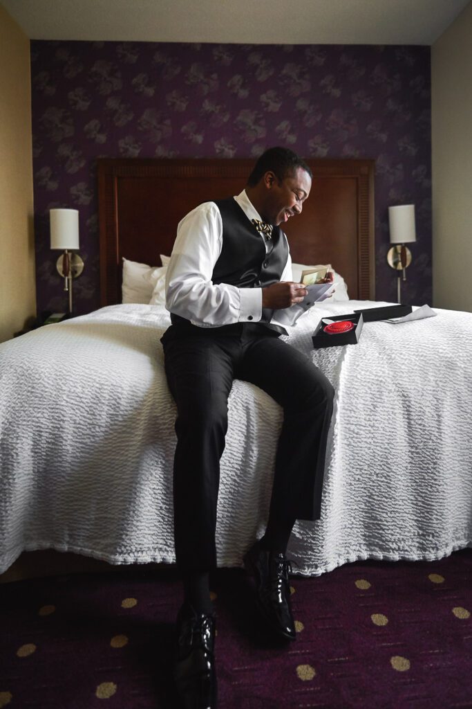 Groom reading letter from bride in Kansas City room