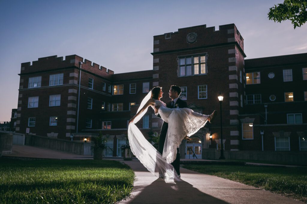 groom twirling bride backlit stephens college