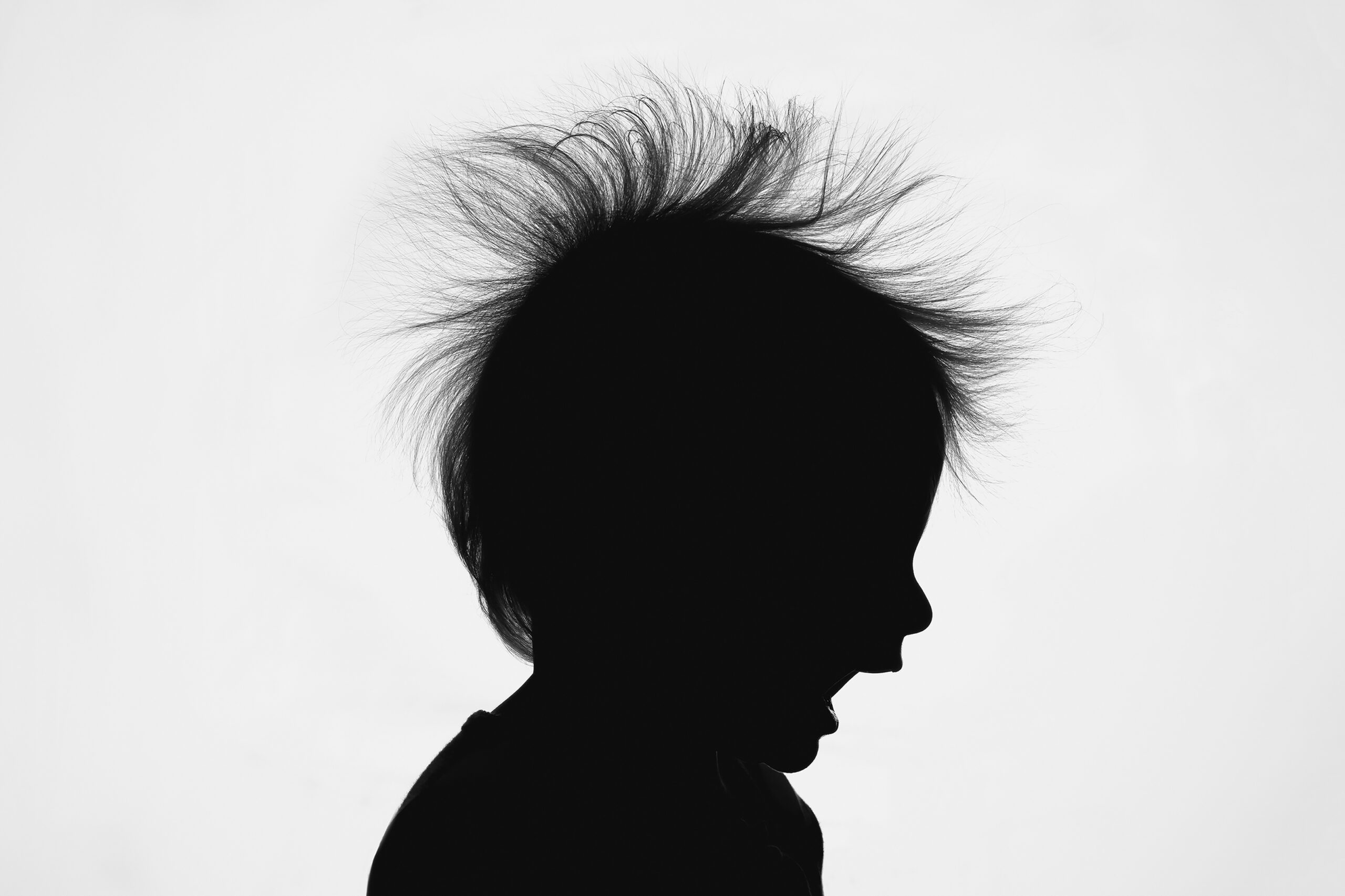 smiling child silhouette with hair standing up