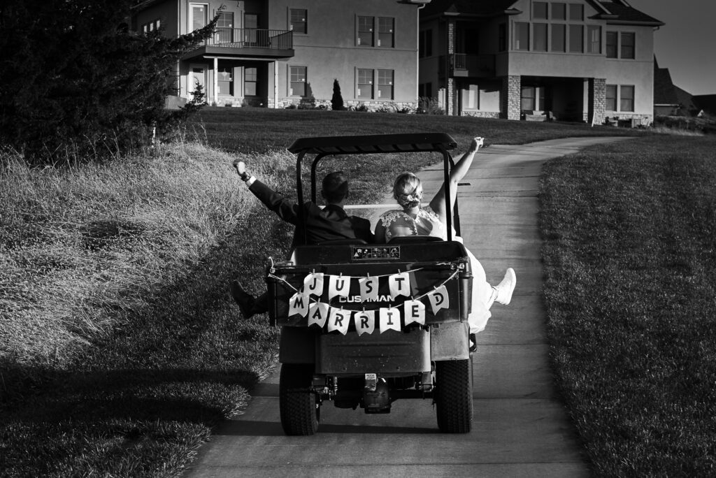 bride and groom just married golf cart
