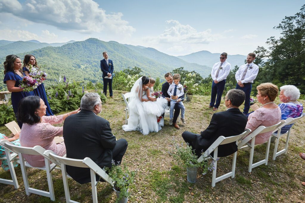 Bride and Groom reading to kids during ceremony North Carolina
