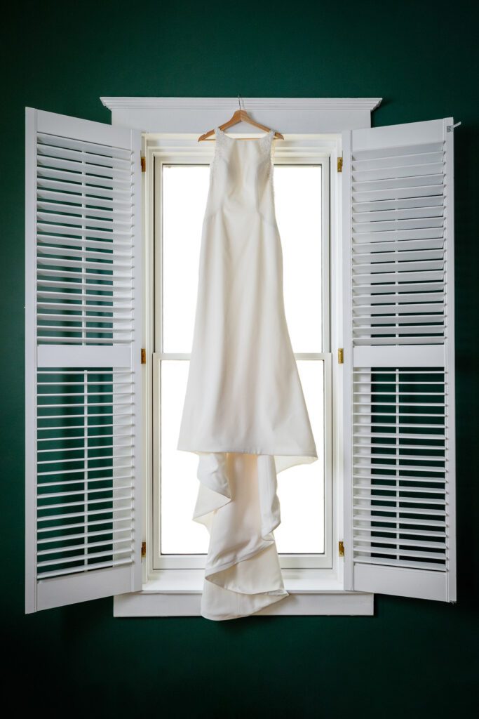 bride dress hanging in window