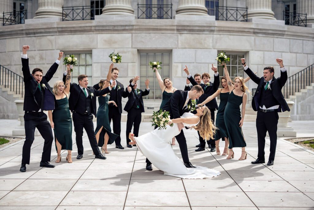 bridal party cheering on bride and groom