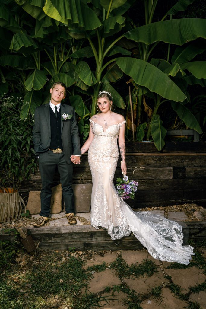 bride and groom in tropical plant setting