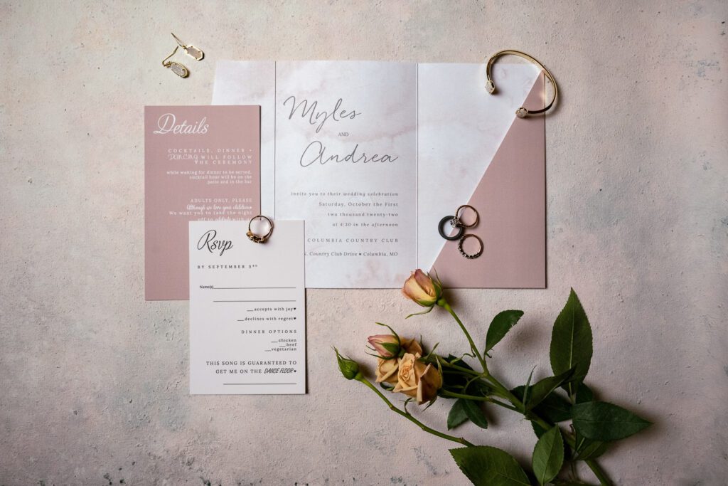 flatlay of wedding invites on backdrop