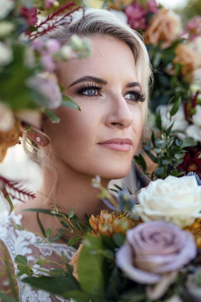 bride looking through bridesmaids flowers