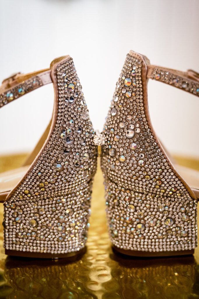 sparkly shoes holding a wedding ring