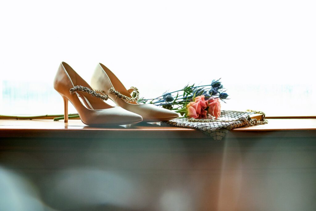 Wedding shoes and flowers on a window seal