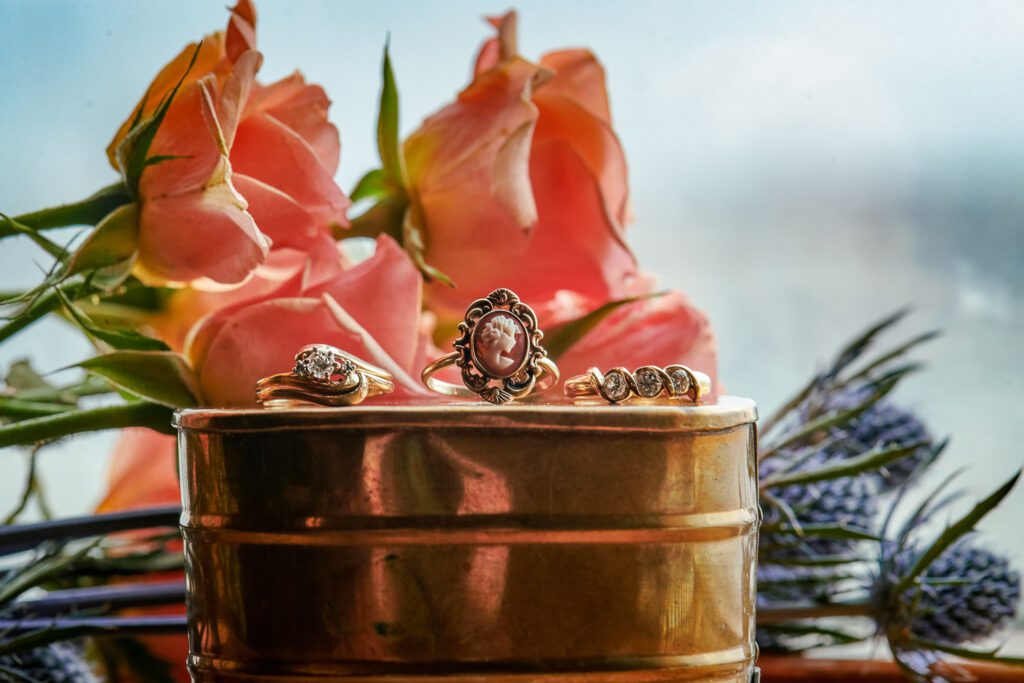 cameo ring on tin can in front of flowers