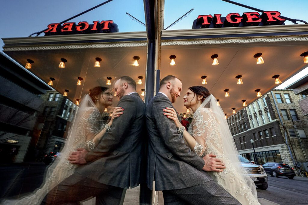bride lounging against groom outside of Tiger Hotel