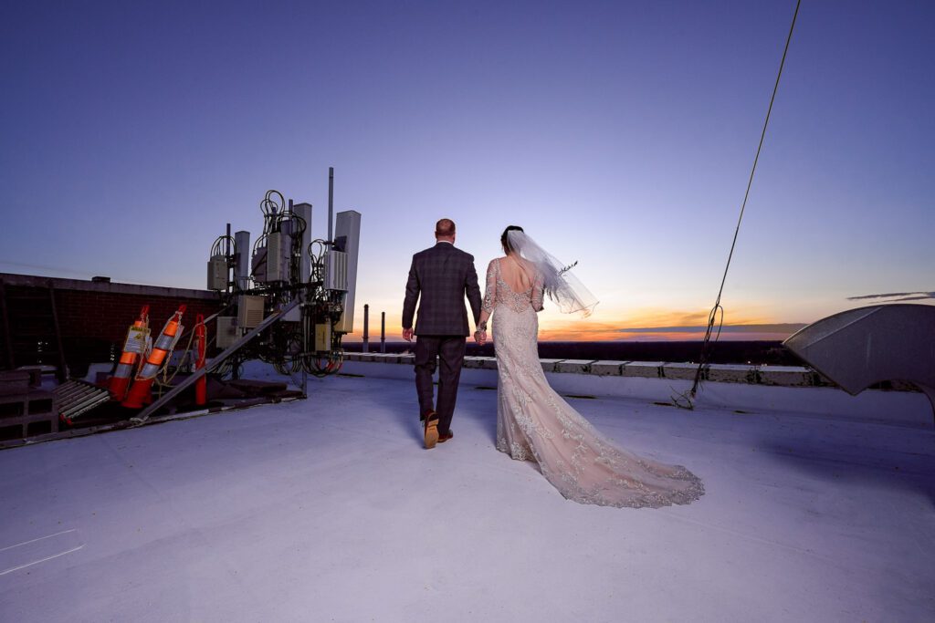 bride and groom at sunset on roof of hotel