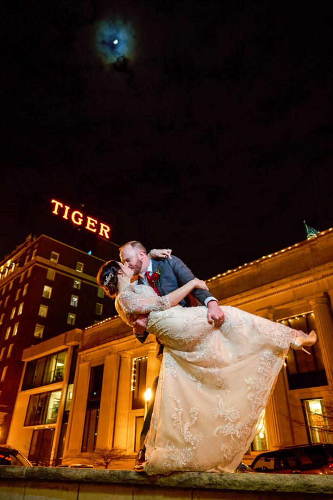 groom dipping bride downtown