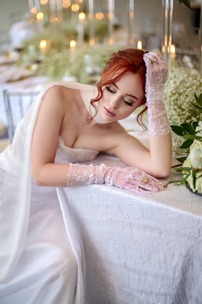bride in gloves resting head on table