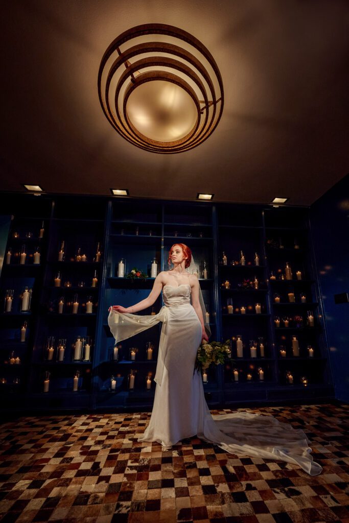 bride in art deco room with candle lit wall