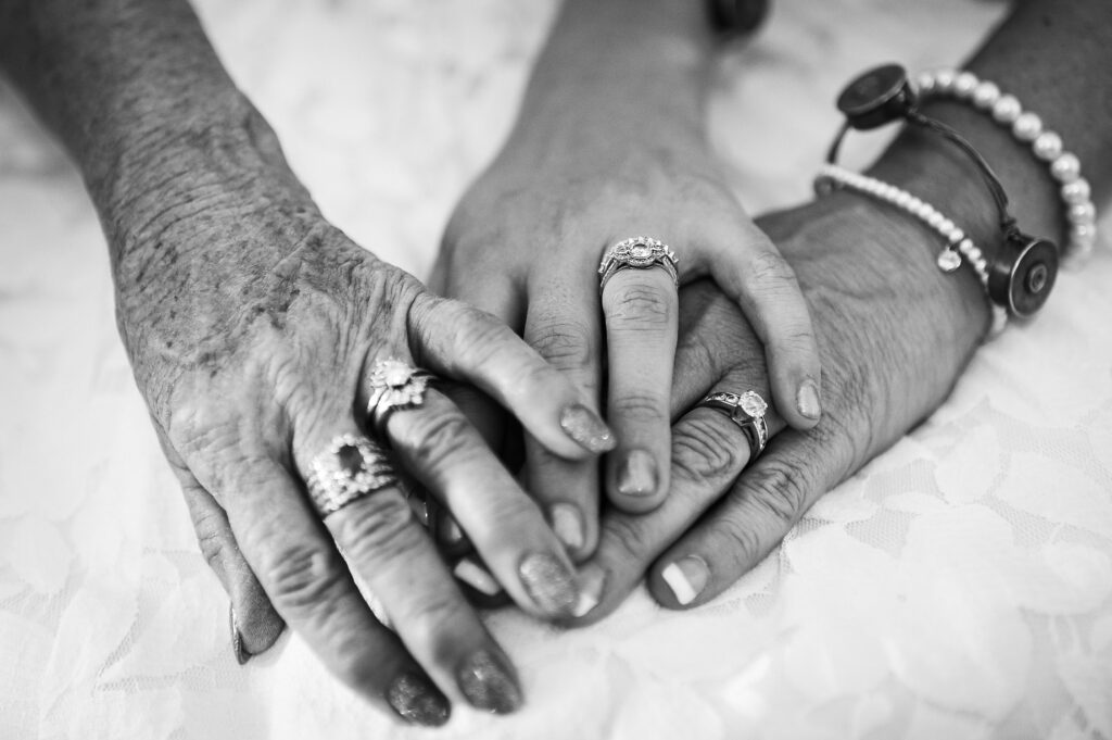 three generations of hands at wedding