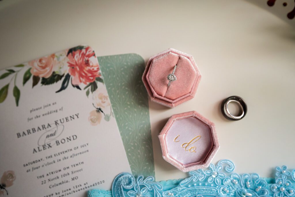 flat lay of ring in velvet box with engagement ring and wedding program Columbia, MO