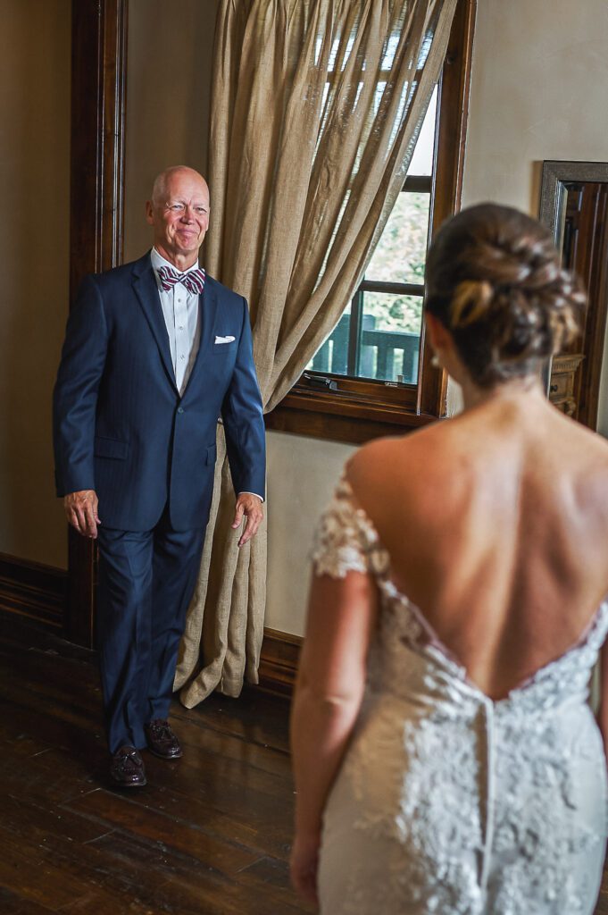 dad smiling at daughter wedding first look
