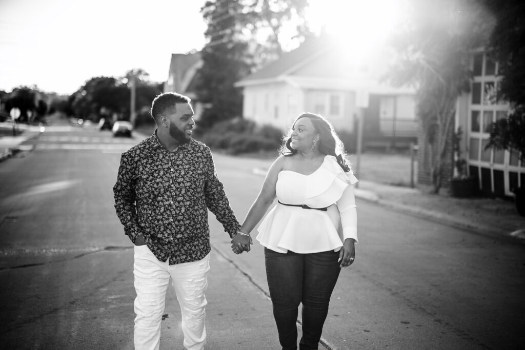 Tierre and Anthony, a black couple, hold hands while walking in street.