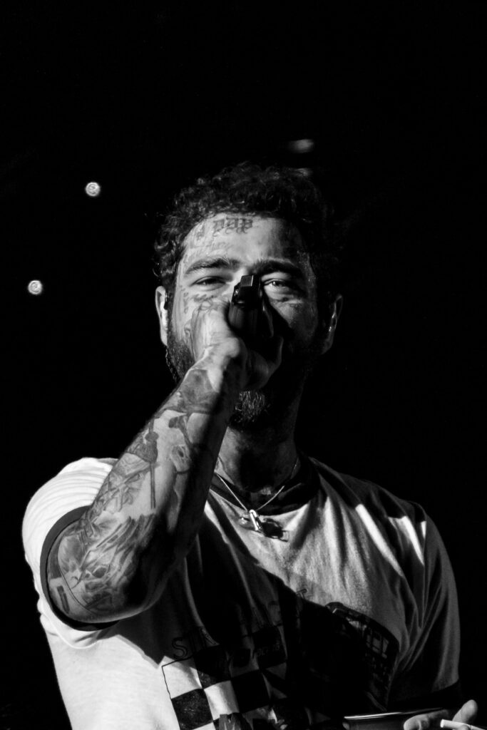 post malone sings into microphone while looking at camera in st louis missouri