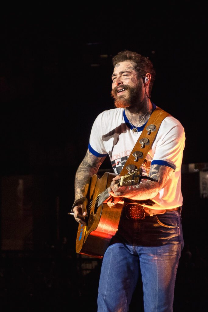 post malone plays guitar with cigarette in between fingers busch stadium st louis mo