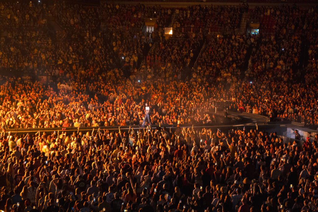 post malone on stage in front of large crowd at Busch Stadium in St. Louis Missouri