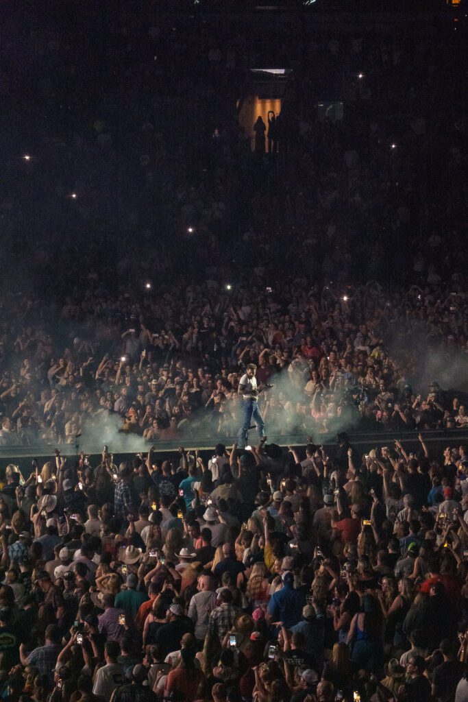 post malone on stage in front of large crowd at Busch Stadium in St. Louis Missouri