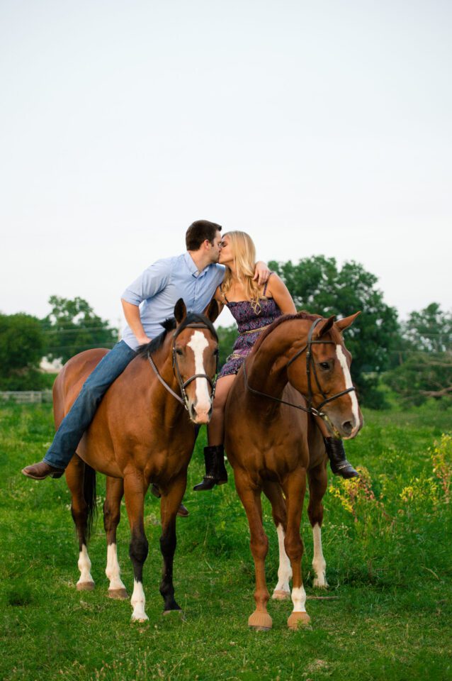 Couple kiss while riding horses