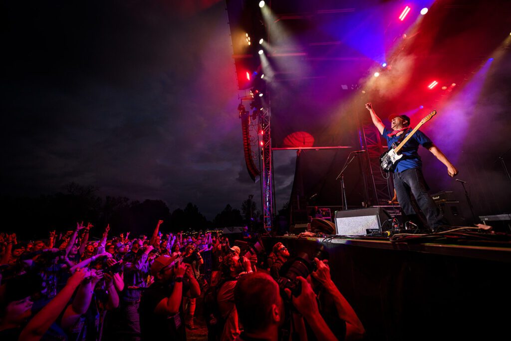 Tom Morello poses in front of crowd on stage