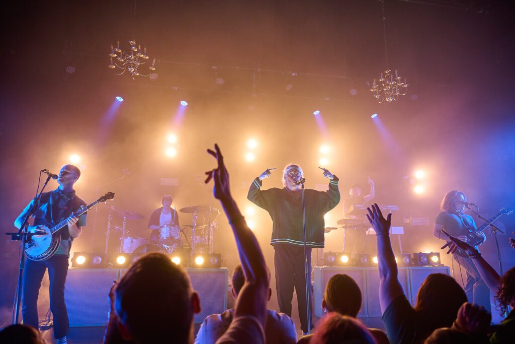 Judah and the Lion perform with hands raised.