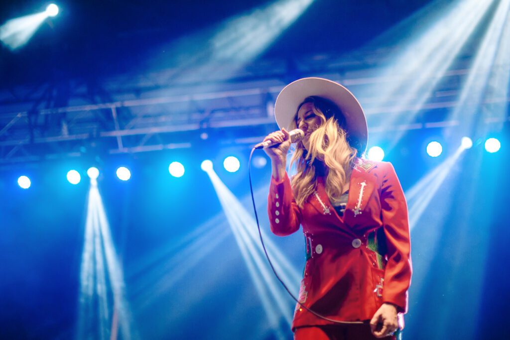 Margo Price wearing red Cowboy suit by Ashley Evans Western Wear.