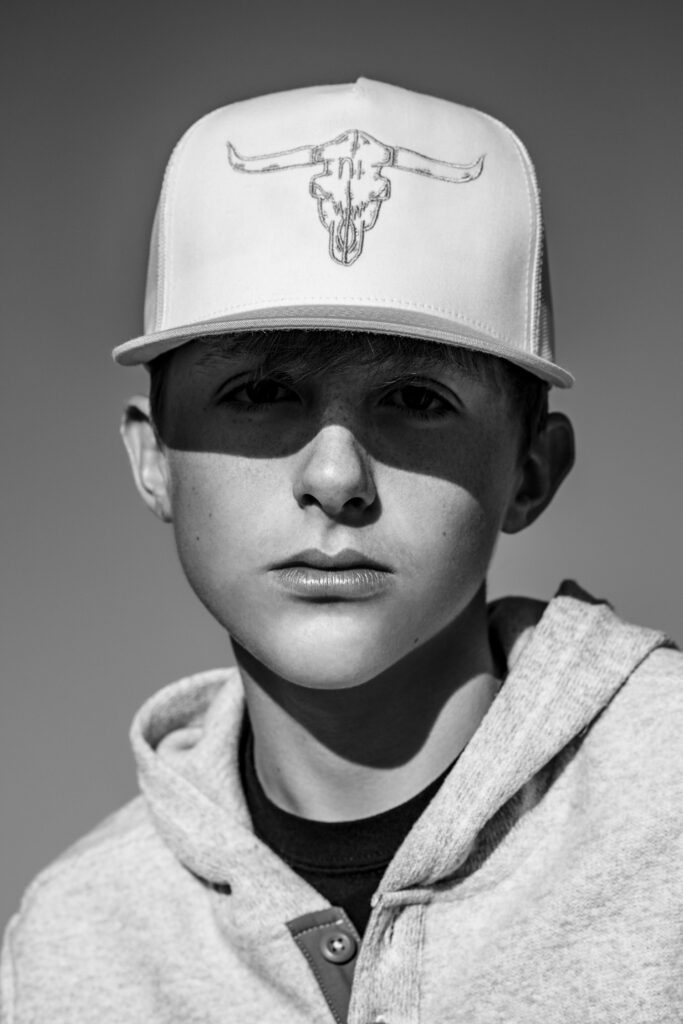 senior guy wearing long horn ball cap with shadow over eyes