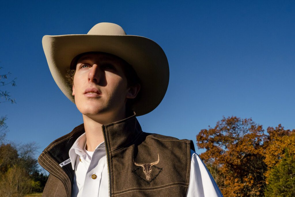Senior guy in columbia missouri wearing cowboy hat in fall field