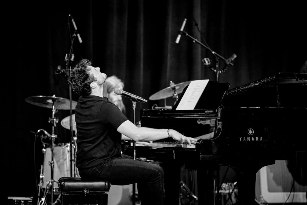 Jacob Tolliver sings into microphone during Jerry Lee Lewis Tribute Show