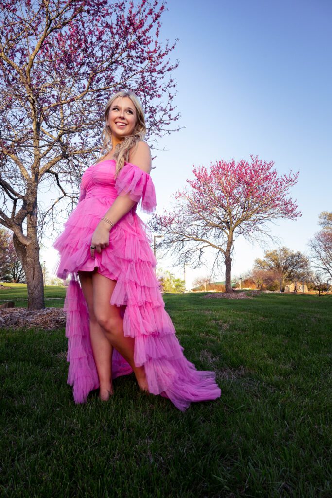 white senior girl wearing fluffy pink dress