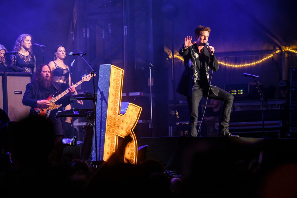 Brandon Flowers and the Killers on stage in suit