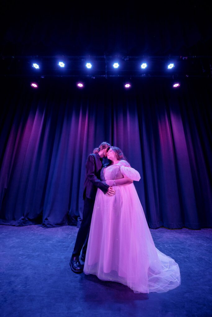 Fairy tale maternity session with colorful pink and purple lights.