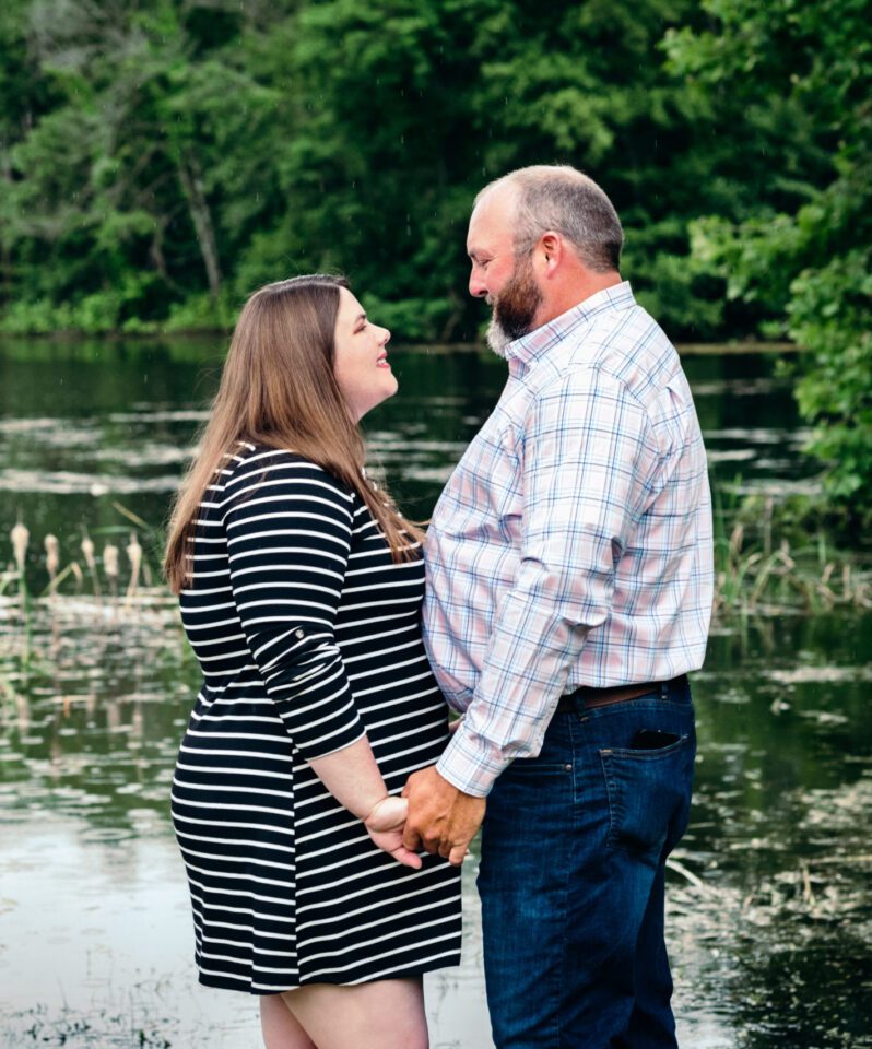 Couple holding hands near water