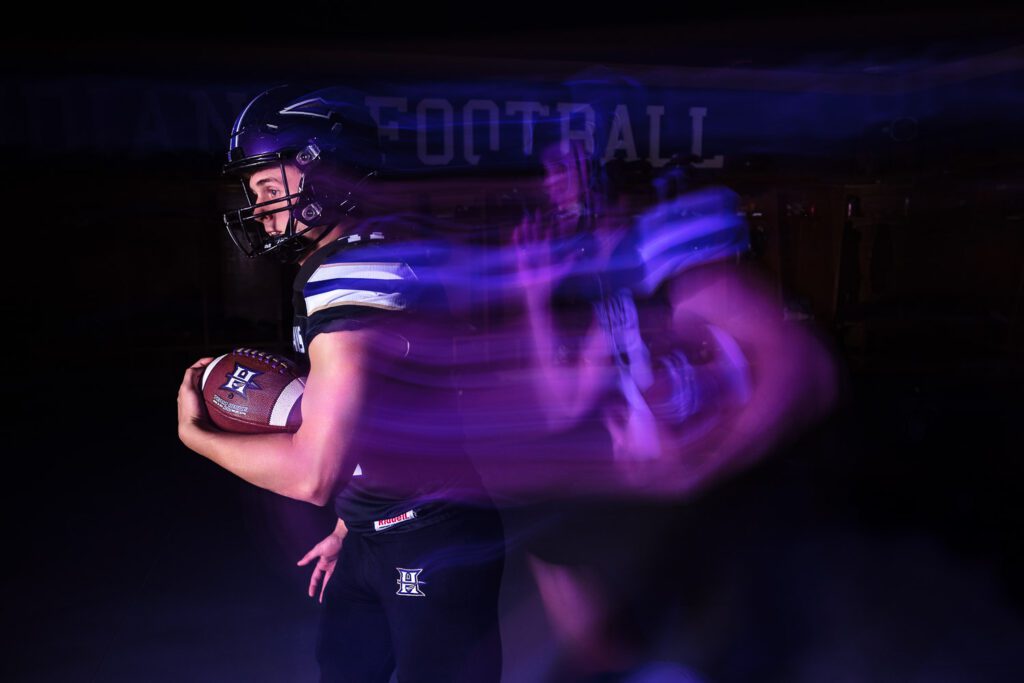 Hallsville senior portrait of football player running with slow shutter
